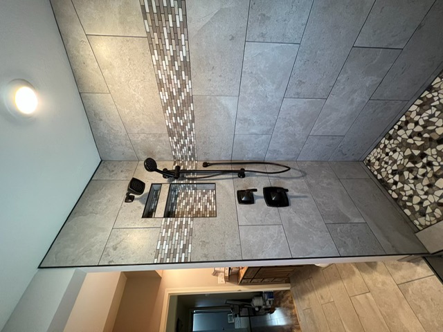 Tiled walk-in shower with a rain head and dual body sprays